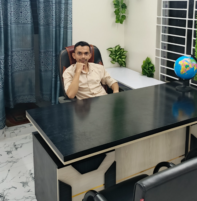 Mohammed Atiqul Islam seated at his office desk